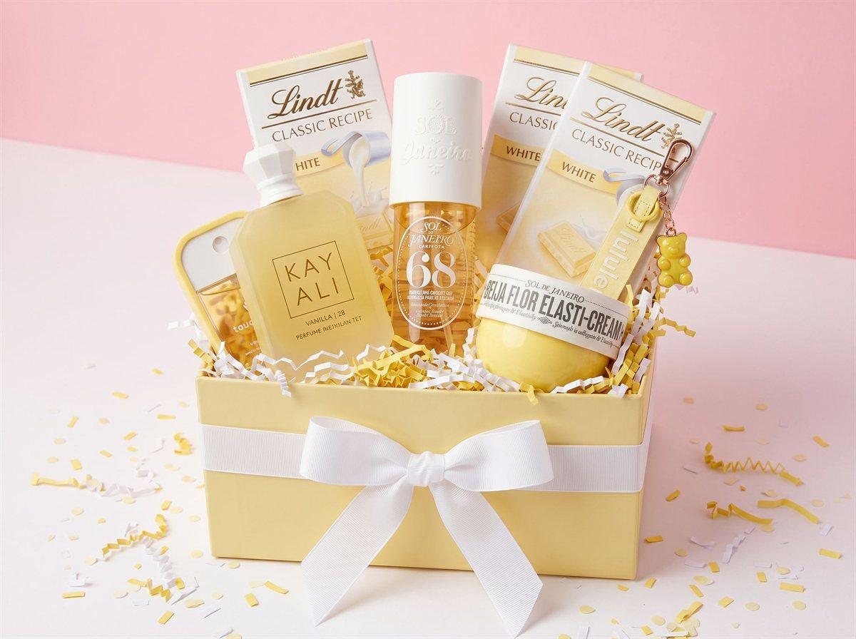 A yellow gift box with something sweet in it, tied with a white bow