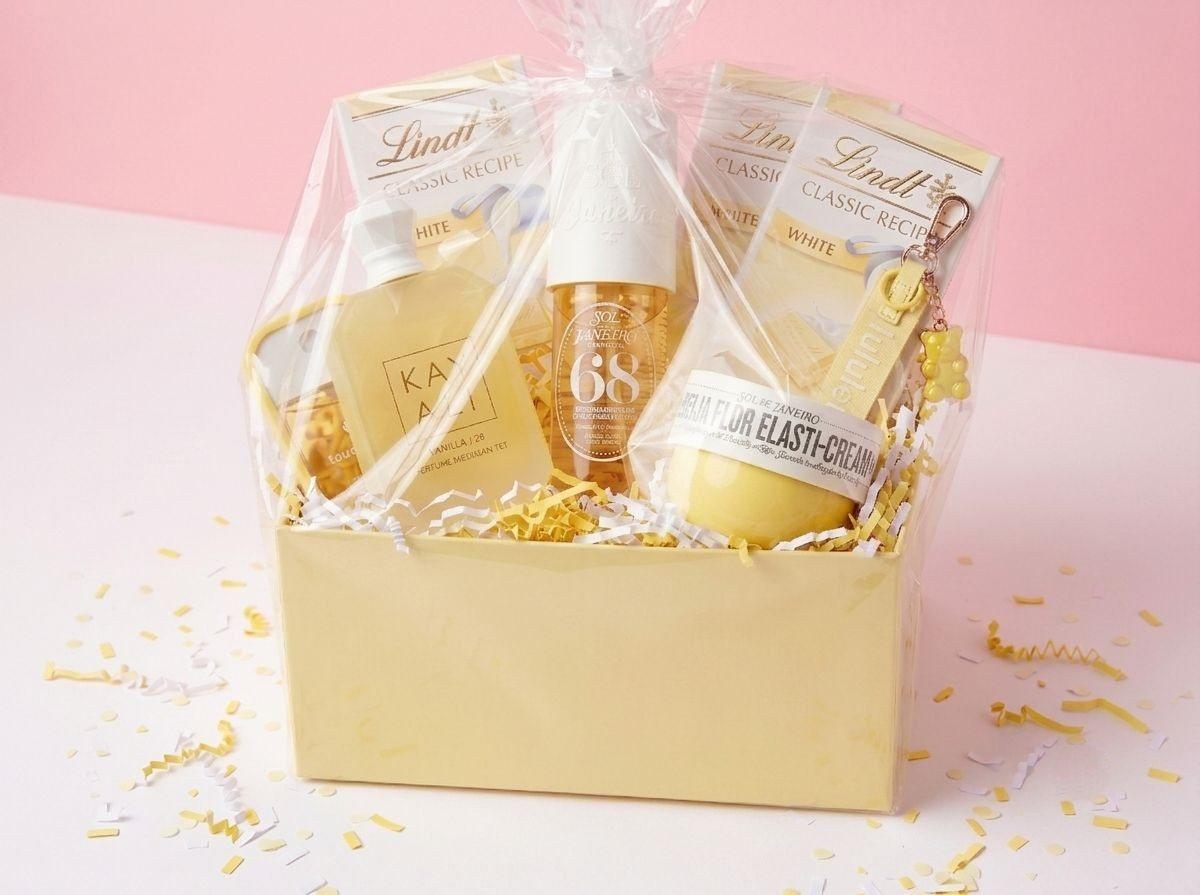 A yellow gift box wrapped and tied with a white bow