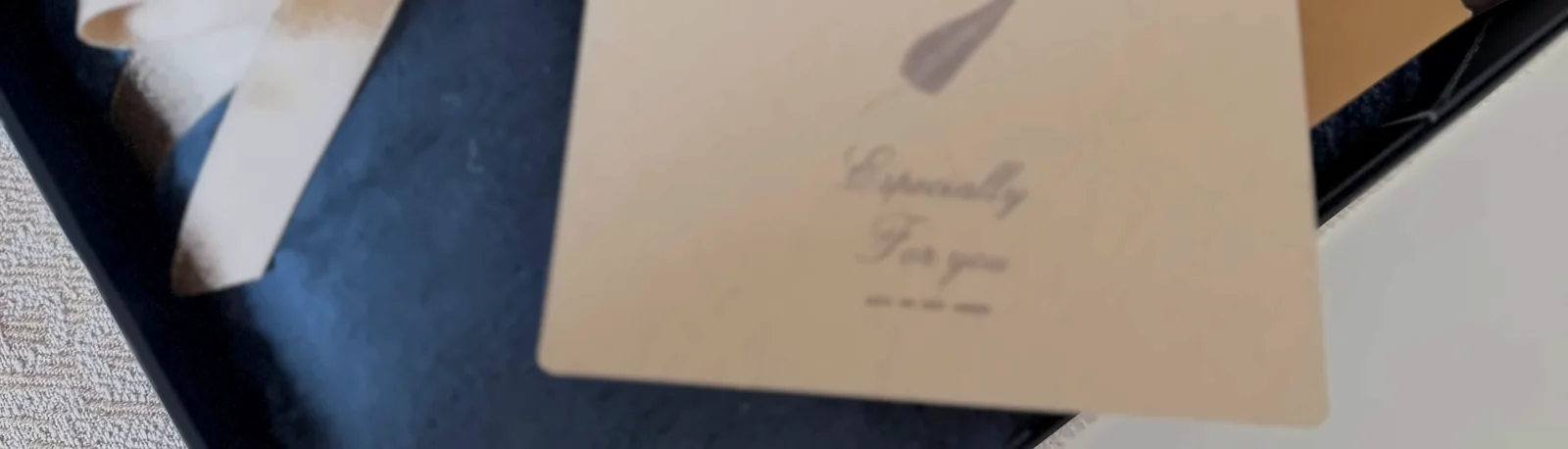 A card resting on top of the things in the navy box