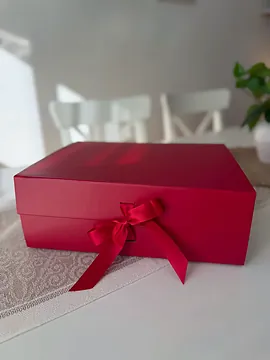 The red box closed, with a red satin bow tied at the front